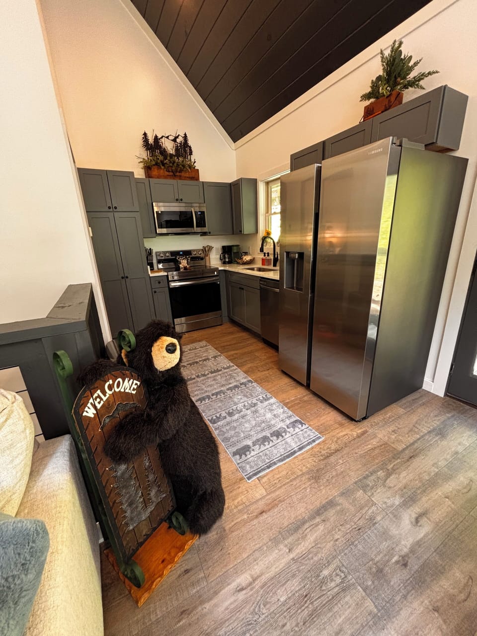 Fully stocked kitchen with quartz countertops and stainless steel appliances.