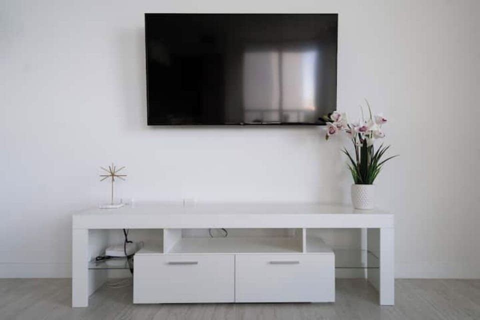 The living room features a large smart TV for entertainment.