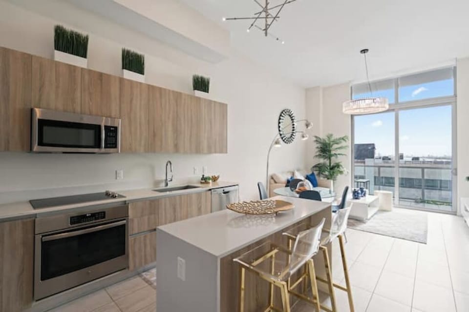 Modern kitchen with sleek countertops and stylish pendant lighting.