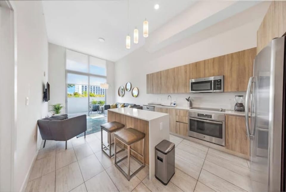 Fully equipped kitchen with sleek modern appliances and stylish lighting.