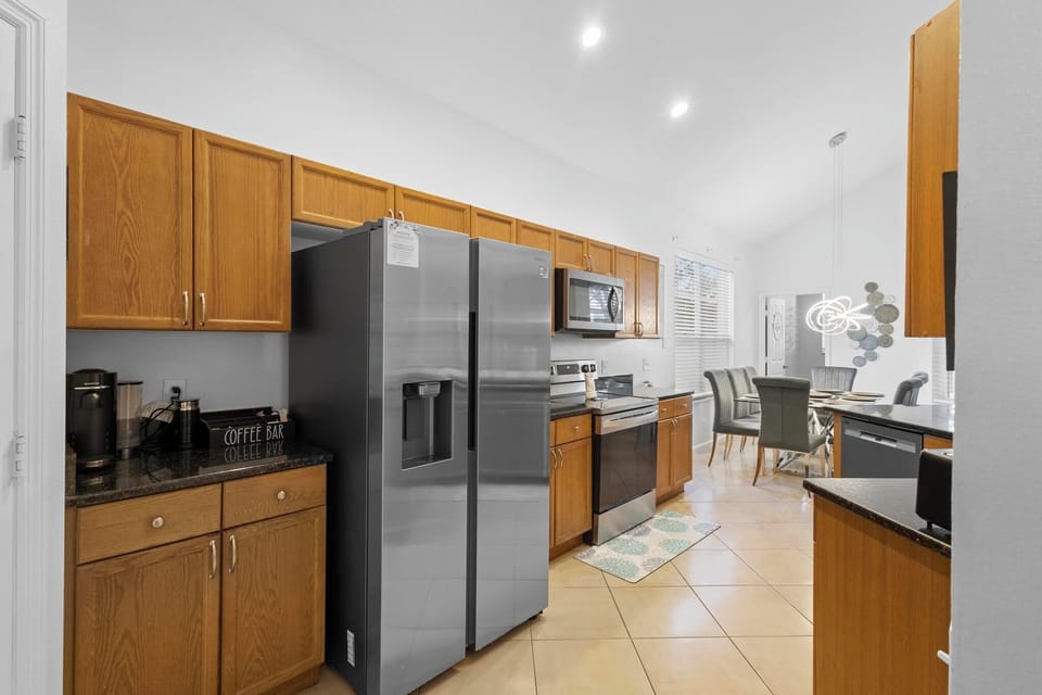 The fully equipped kitchen with granite countertops is ready for your MasterChef skills.