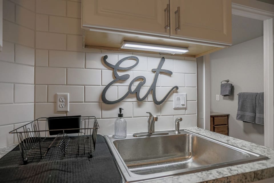 Fully equipped kitchen with stainless steel appliances, perfect for cooking homemade meals during your stay. Enjoy the convenience of a coffee maker, microwave, and a large refrigerator.