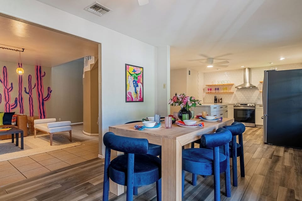 Dining area w/ 6 plush seats, in an open floor with the living room and kitchen