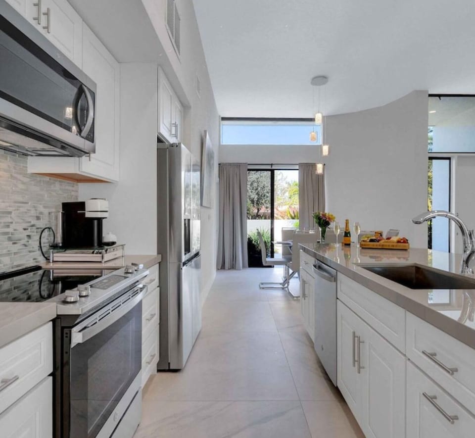 New chef's kitchen w/ island seating up to 6. Full frig, microwave, oven/stove.