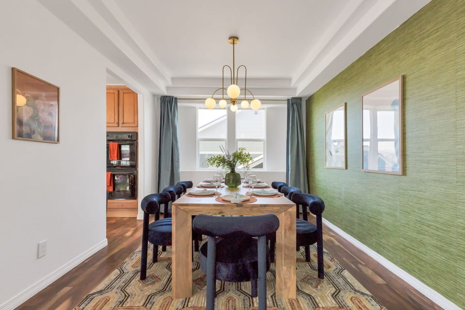 Dining room with 8 plush seats and an elegant chandelier