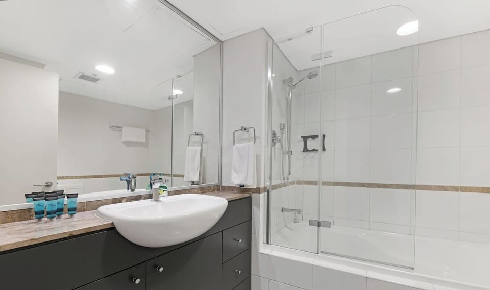 Fresh and functional bathroom with bath and shower