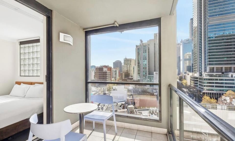 a small white bistro table and chairs out on the balcony