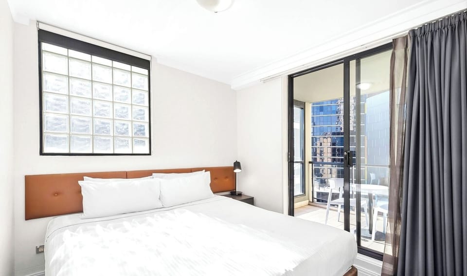 clean bedroom setup featuring crisp white bedding