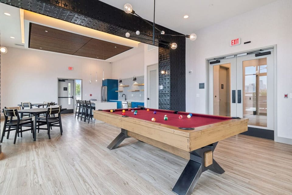Enjoy the shared club room at Crescendo—pool table, full kitchen/bar seating, lounge space, and access to the rooftop lounge for epic hangouts and city views!