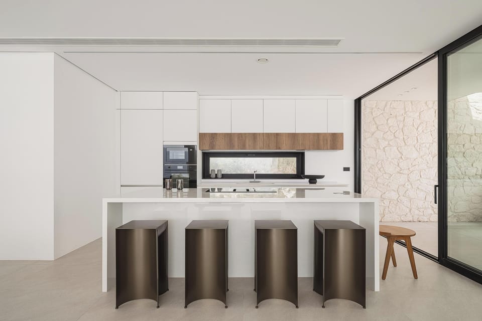 The island with its four sleek stools, creates the perfect setting for your morning coffee.