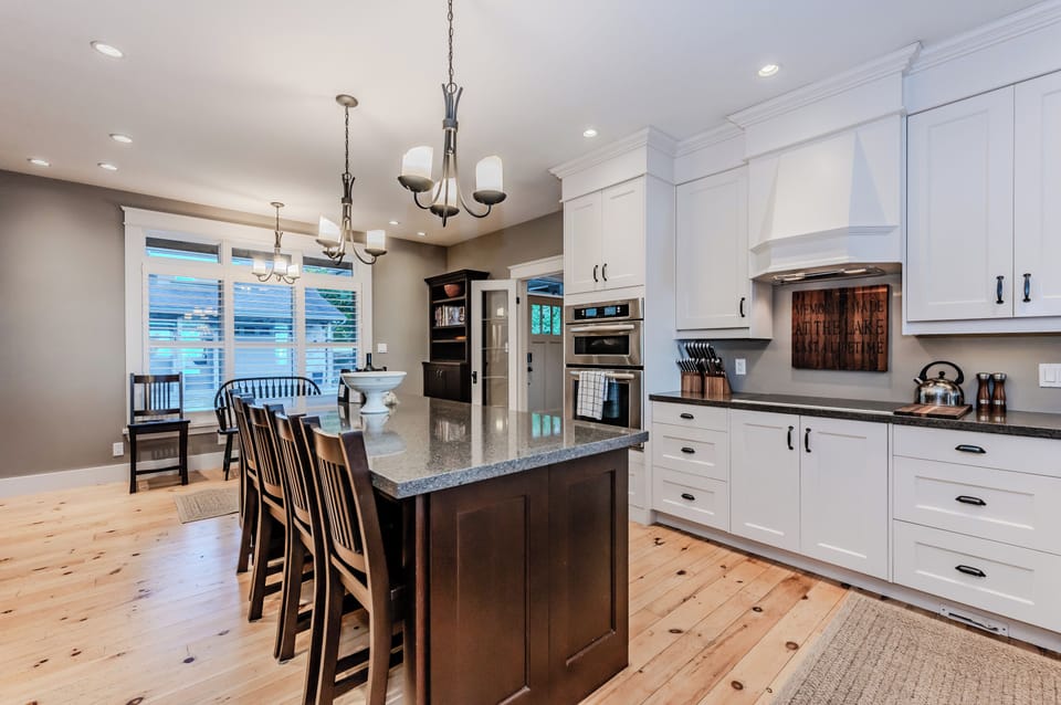 A bright, well-equipped kitchen with a large island, modern appliances, and ample seating, providing a perfect space for cooking and socializing