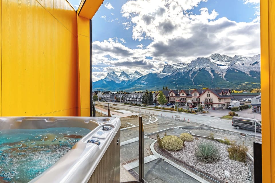 Relax in the outdoor hot tub and enjoy stunning mountain scenery. 