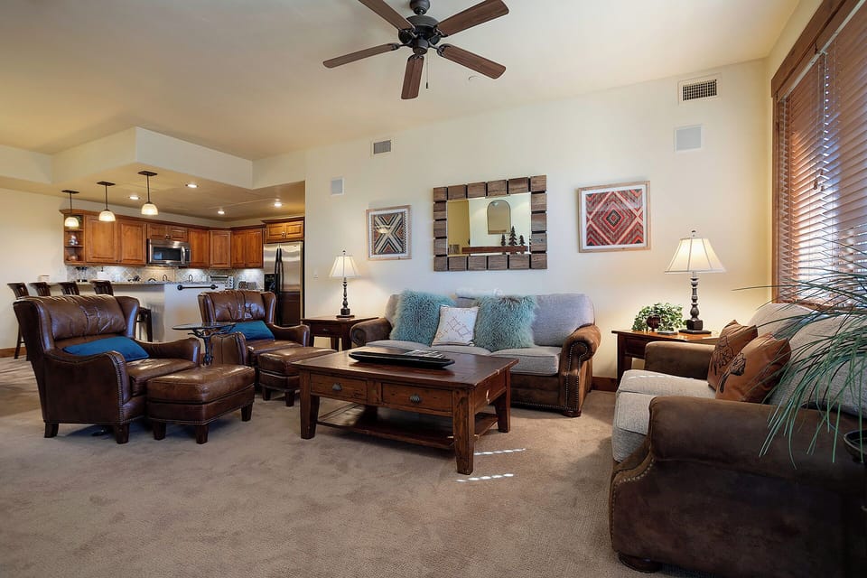 Unwind in your spacious living room where rich leather seating and warm wood accents create the perfect atmosphere for relaxation.