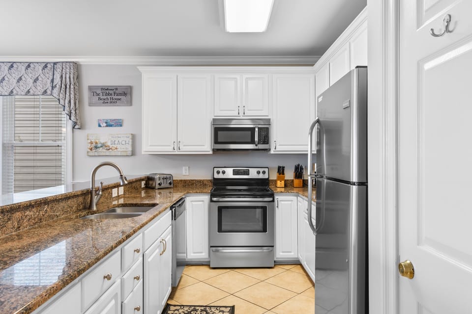 Your fully equipped kitchen features granite countertops, stainless steel appliances, and everything you need to create memorable meals during your stay.