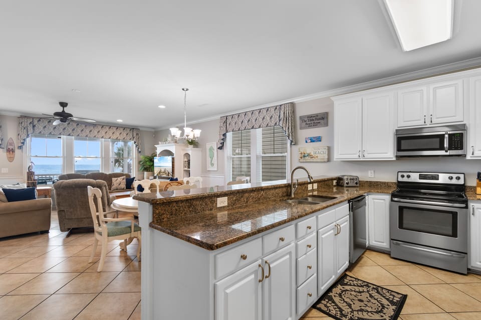 Your spacious kitchen flows seamlessly into the living area, where sparkling granite counters and ocean views create the perfect backdrop for your getaway.
