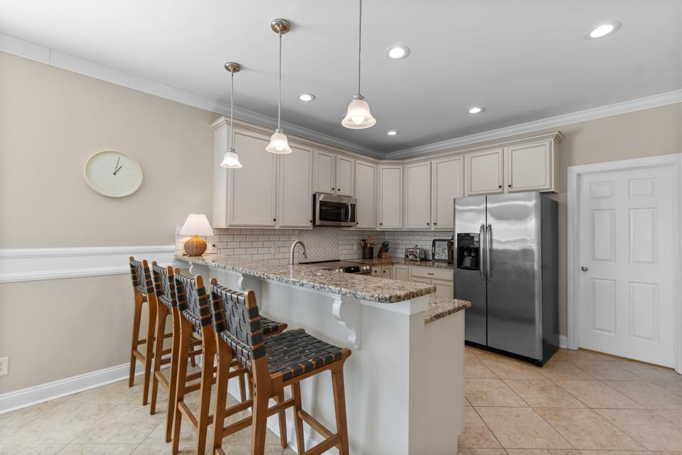 Your bright, modern kitchen features granite countertops, stainless appliances, and a breakfast bar where you can sip morning coffee while planning your day.