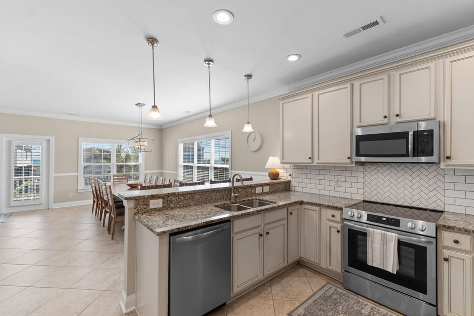 Your spacious kitchen features granite countertops, modern appliances, and a large island perfect for preparing meals and gathering with loved ones.