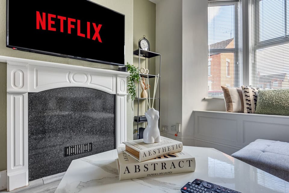 A cosy living room with a large corner sofa, 50`` Smart TV with Virgin and Netflix subscription included and a work desk, perfect for those working or studying from home.