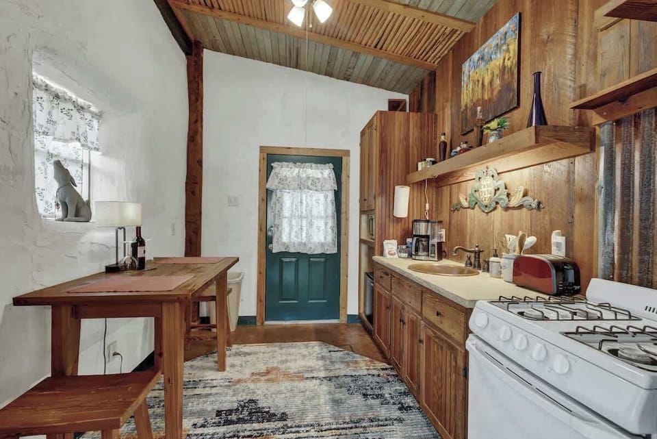 The mini kitchen is equipped with a stove, microwave, coffee pot, toaster and mini fridge.