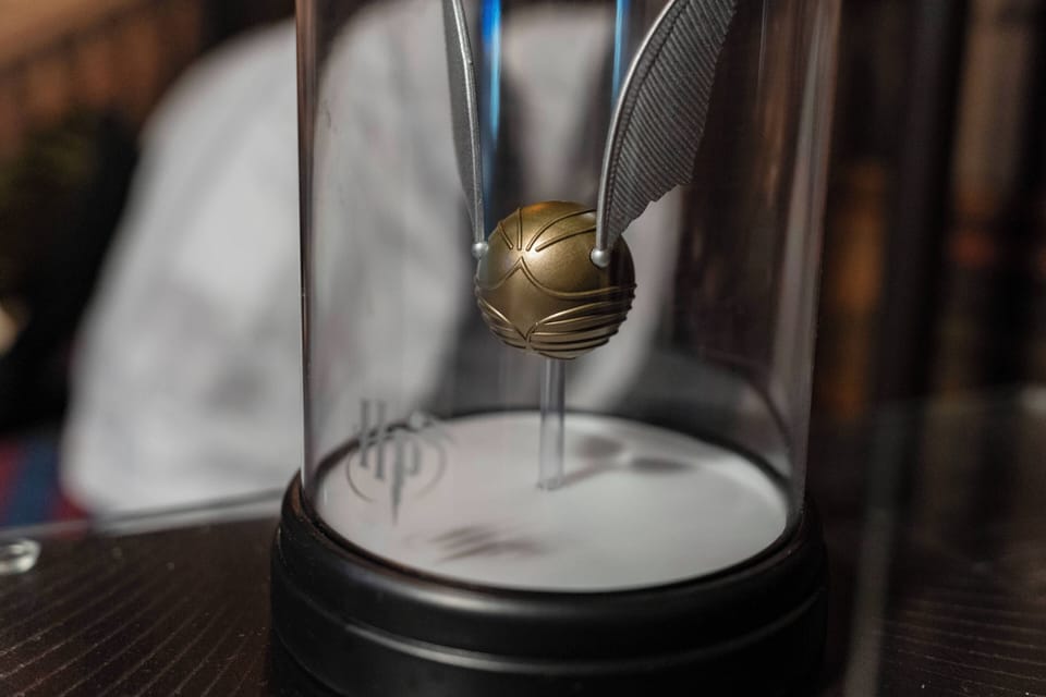 Enhance your stay with this charming decor piece— a golden sphere in a glass display, featuring intricate details and a sleek black base, perfect for sparking delightful conversations. Enjoy a touch of whimsy in your space!