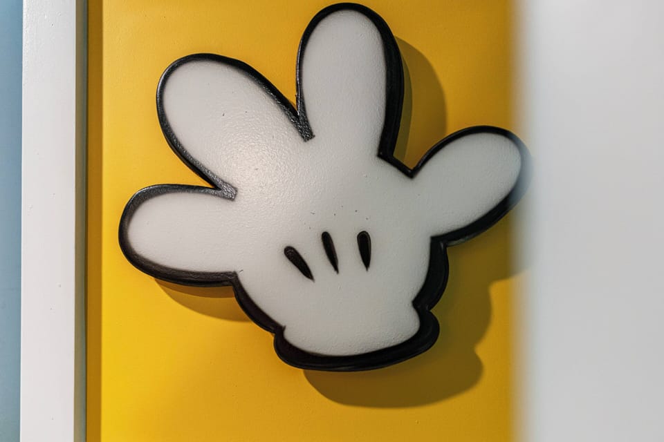 Enhance your stay with playful decor, featuring a charming light fixture shaped like a classic character against a vibrant yellow backdrop. This whimsical touch invites fun and creativity into your experience.