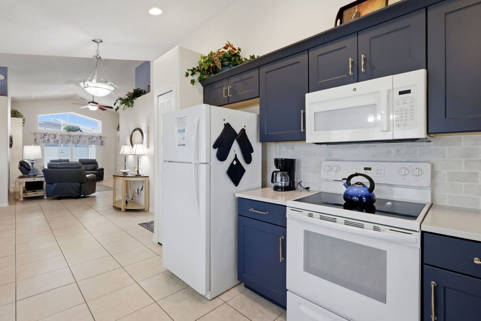 Updated kitchen featuring beautiful navy cabinetry, upgraded counters, and plenty of natural light.