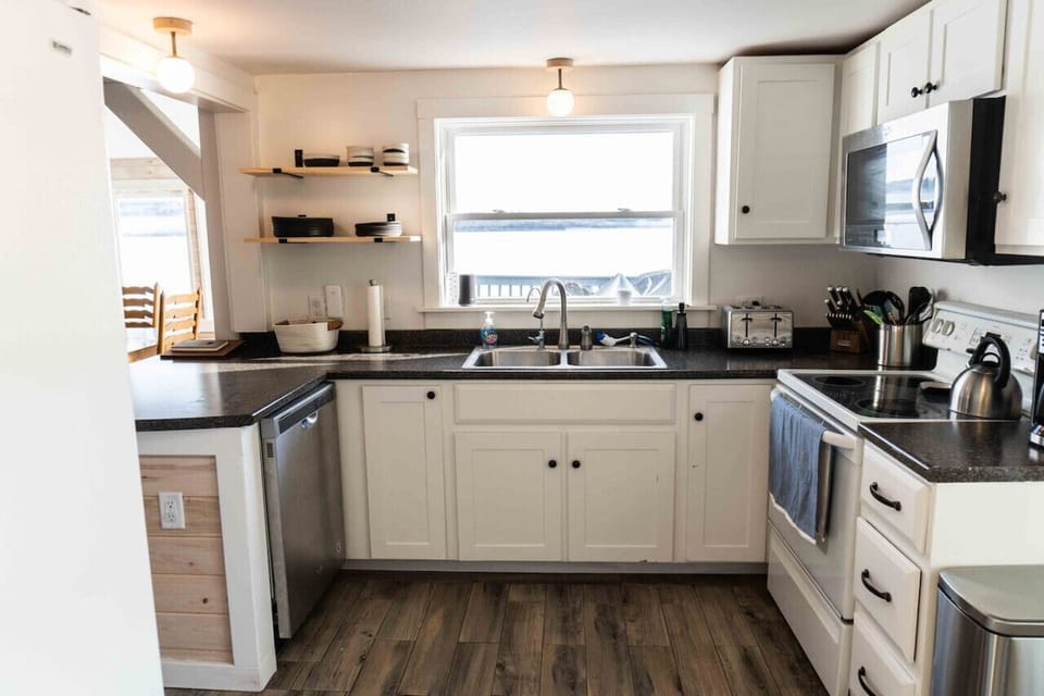 The fully stocked kitchen opens up to the living/dining area.