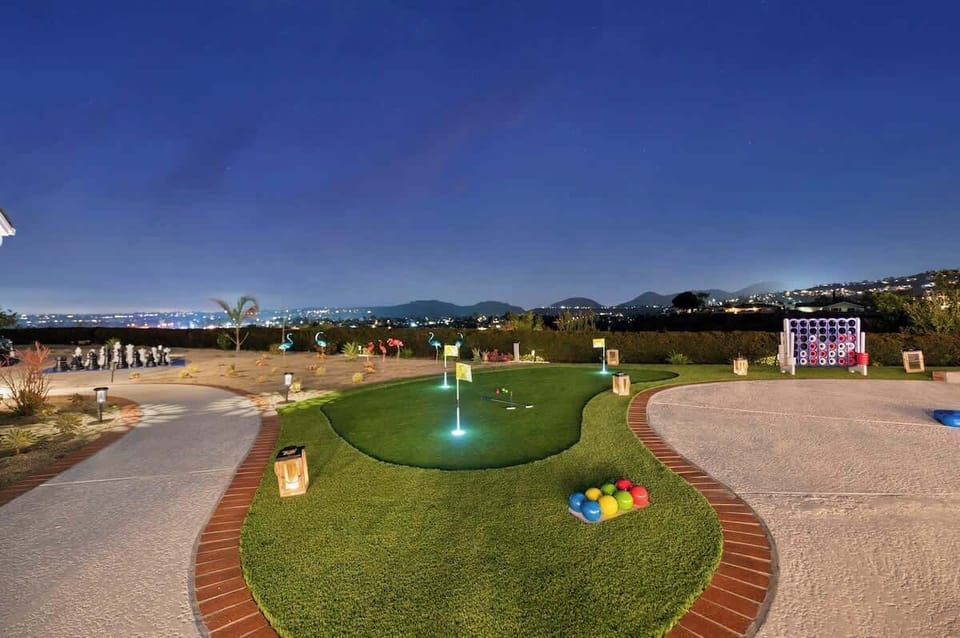 A backyard paradise filled with a plethora of entertainment options, from mini-golf to giant chess and oversized Connect Four—perfect for fun and excitement for all ages! 
