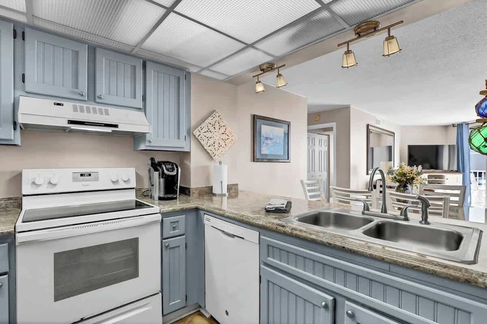 The kitchen provides ample counter space and a light, airy feel, making meal preparation a breeze. 