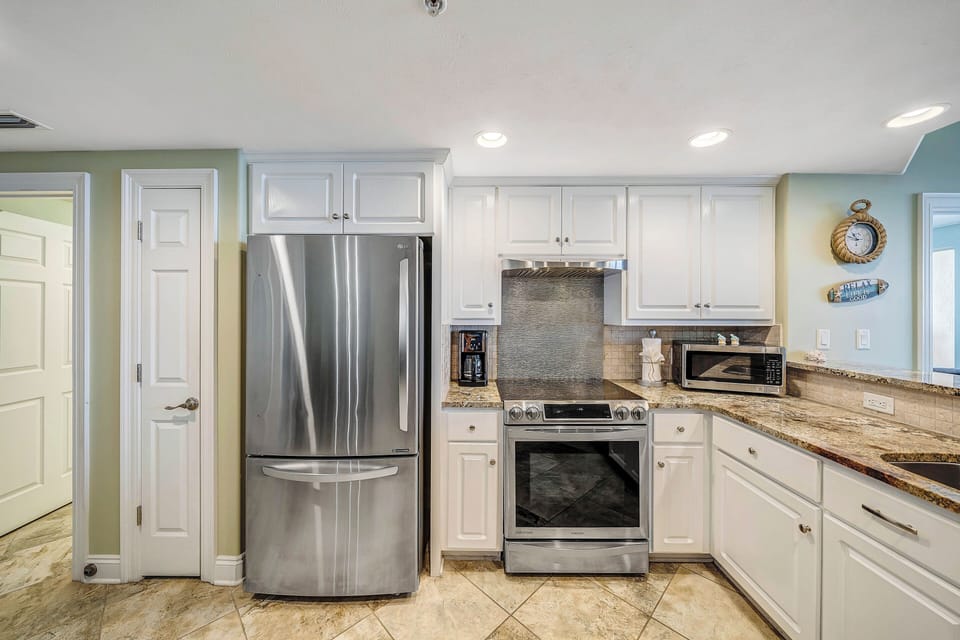 The fully equipped kitchen features granite countertops, stainless-steel appliances, and has everything you need to prepare meals for family & friends.