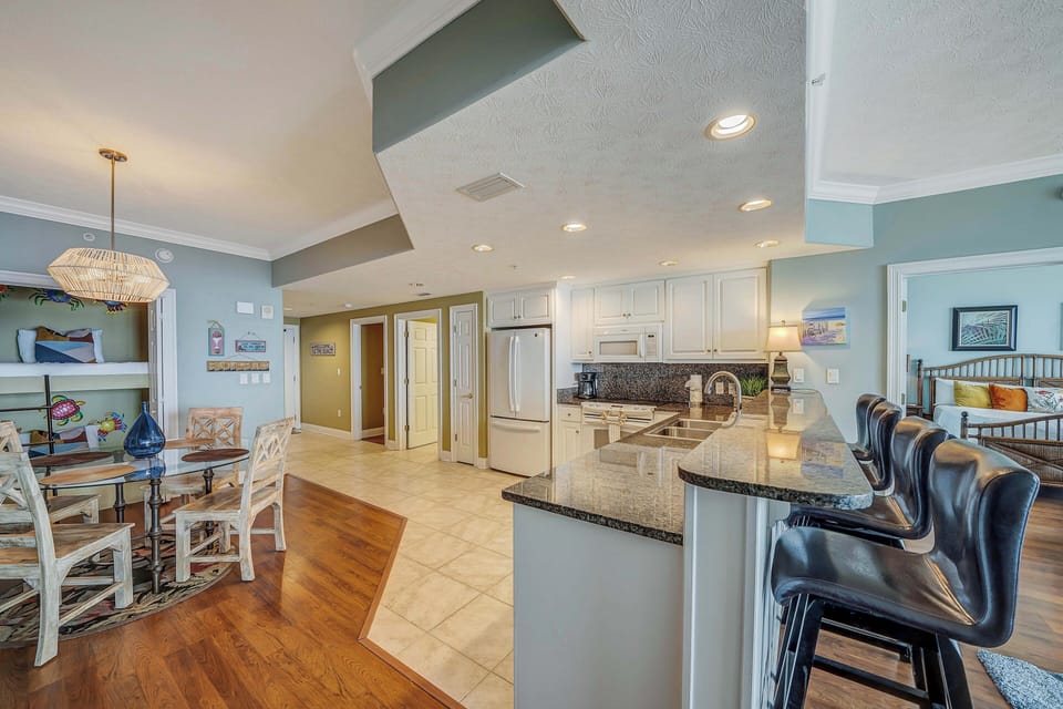 There is a dining table, with additional breakfast bar seating as well.