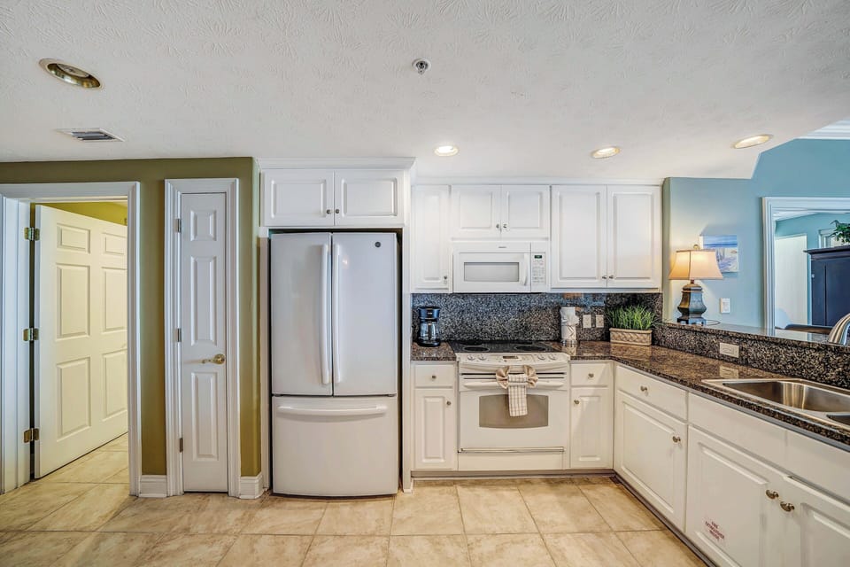 The fully equipped kitchen features granite countertops and everything you need to prepare meals for family & friends.