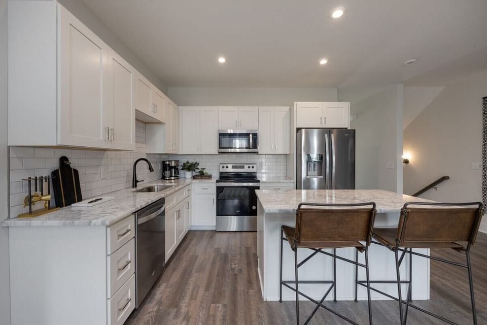Full kitchen with stainless steel appliances and breakfast bar with seating for 2