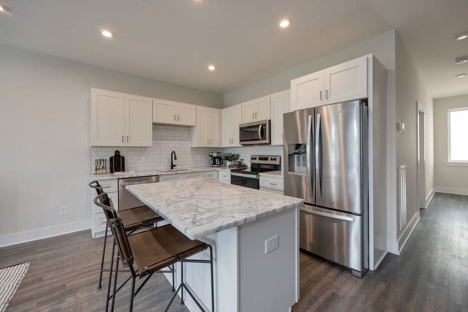 Full kitchen with stainless steel appliances and breakfast bar with seating for 2