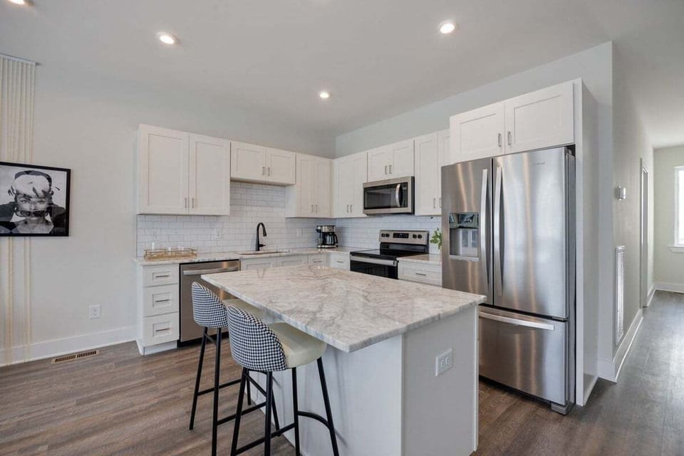 Full kitchen with stainless steel appliances and breakfast bar with seating for 2