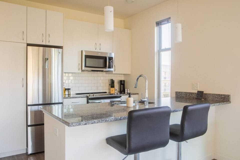 A sun-drenched dining area that doubles as a spacious workstation—perfect for remote work or a morning coffee
