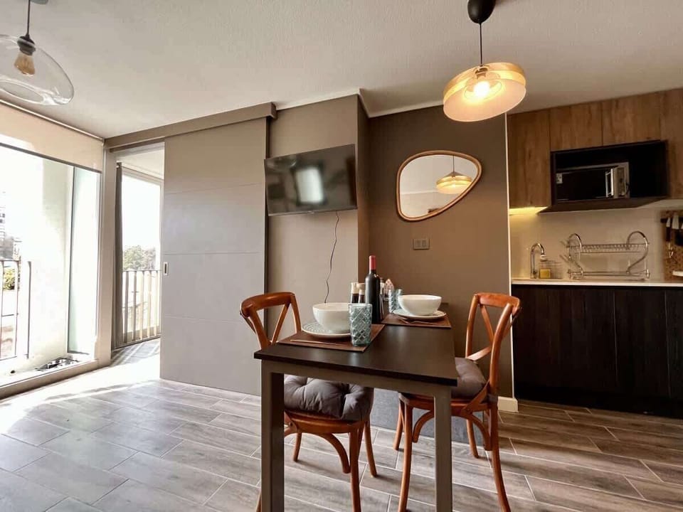 Cozy dining area w/ wood accents & warm lighting beside the kitchen.