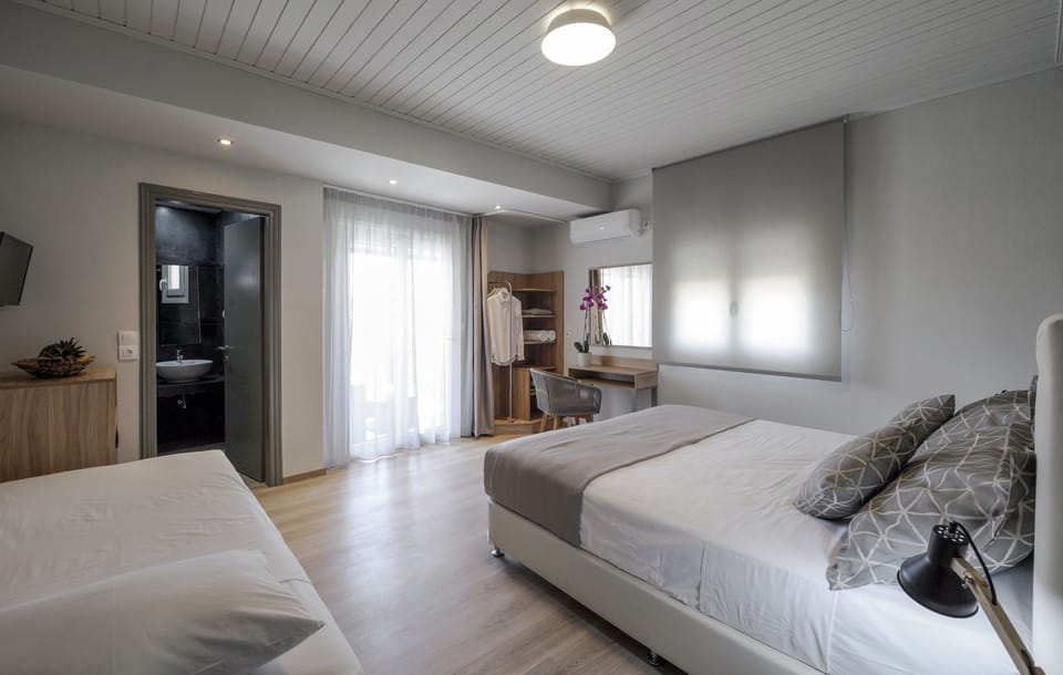 Deluxe Triple Room, Balcony | In-room safe, iron/ironing board, free WiFi