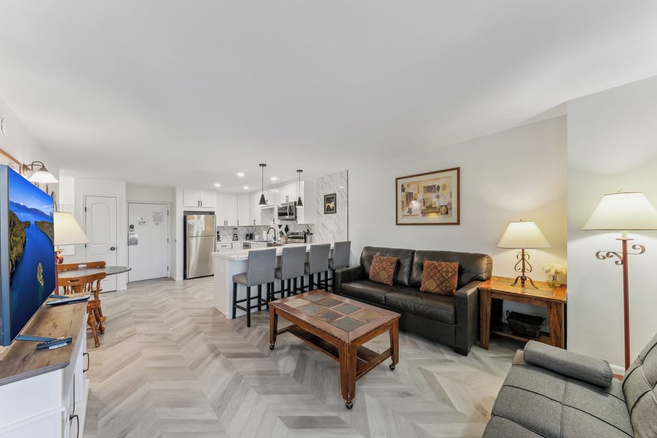 Relax in your open-concept living space with modern kitchen, cozy seating, and thoughtful touches that make you feel right at home.