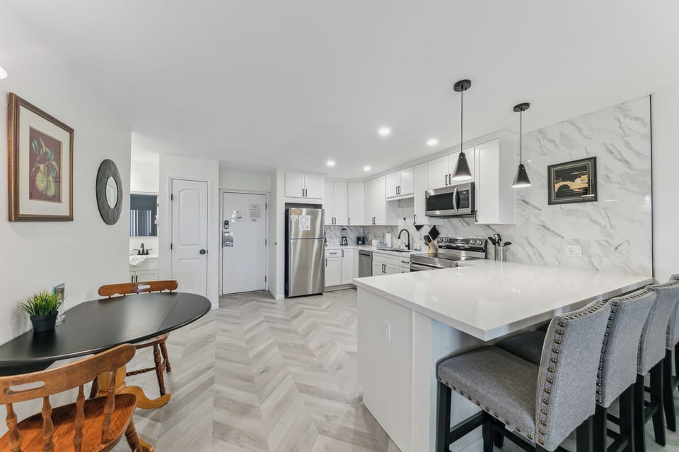 Gather around the spacious island or cozy dining nook in your modern kitchen, complete with marble backsplash and premium appliances.