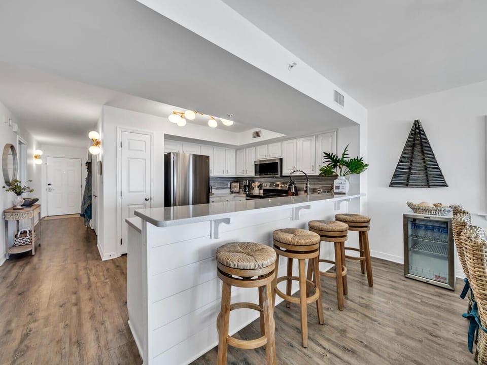 Your fully equipped kitchen features modern appliances, granite counters, and a breakfast bar perfect for casual dining and entertaining.