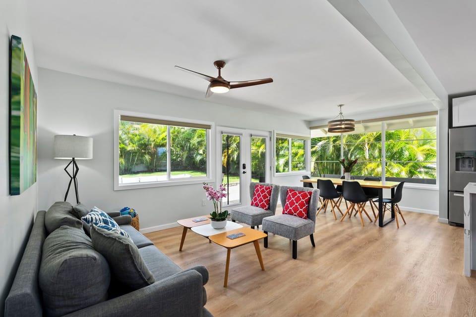Bright and airy, this open-plan living space seamlessly connects the lounge area to the dining room, highlighted by natural light and stylish furnishings.