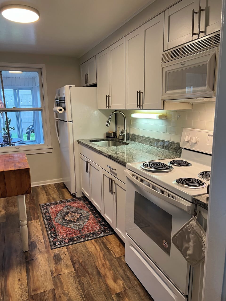 Kitchen with full size refrigerator, oven, stove, microwave and laundry in unit.