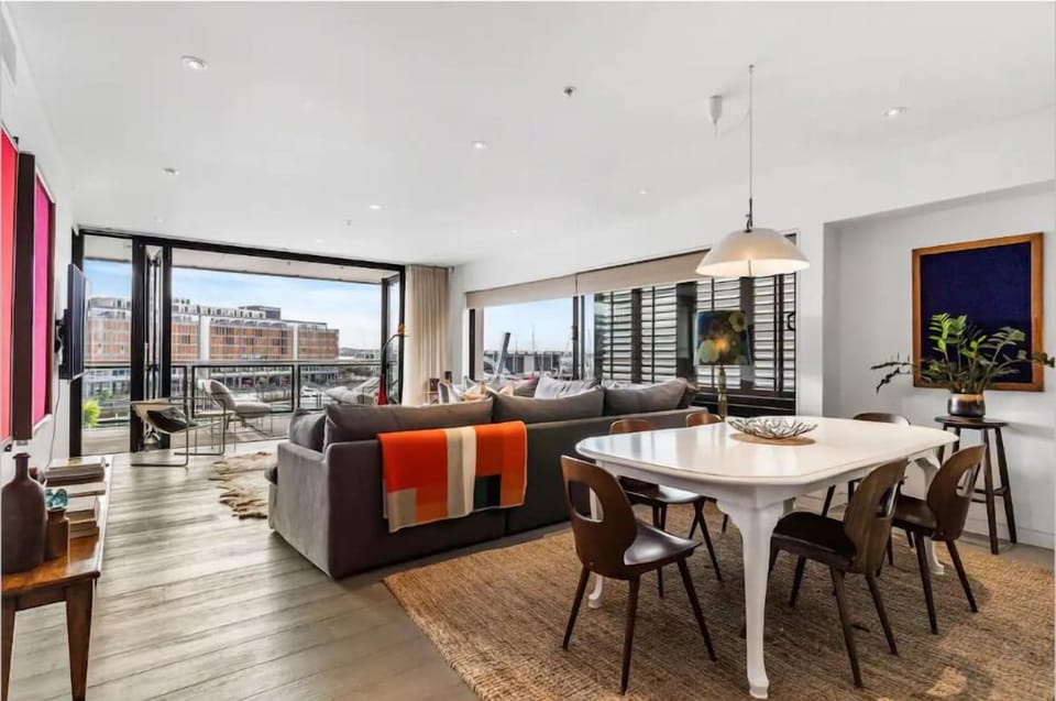 A sun-light filled lounge framed by expansive glass from dawn to dusk.