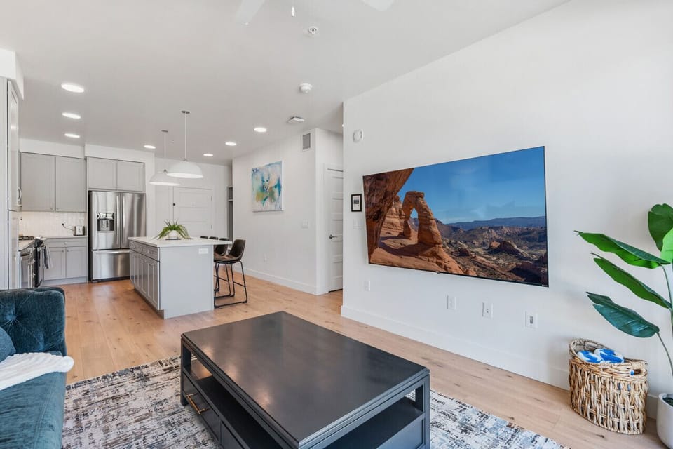Beautifully designed living room. 75` TV, comfy sofa and amazing views of mountains and city skyline.