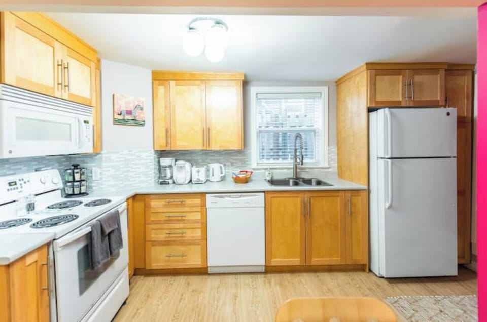 Kitchen stocked with cookware, bakeware, a blender, a George Foreman grill, etc.