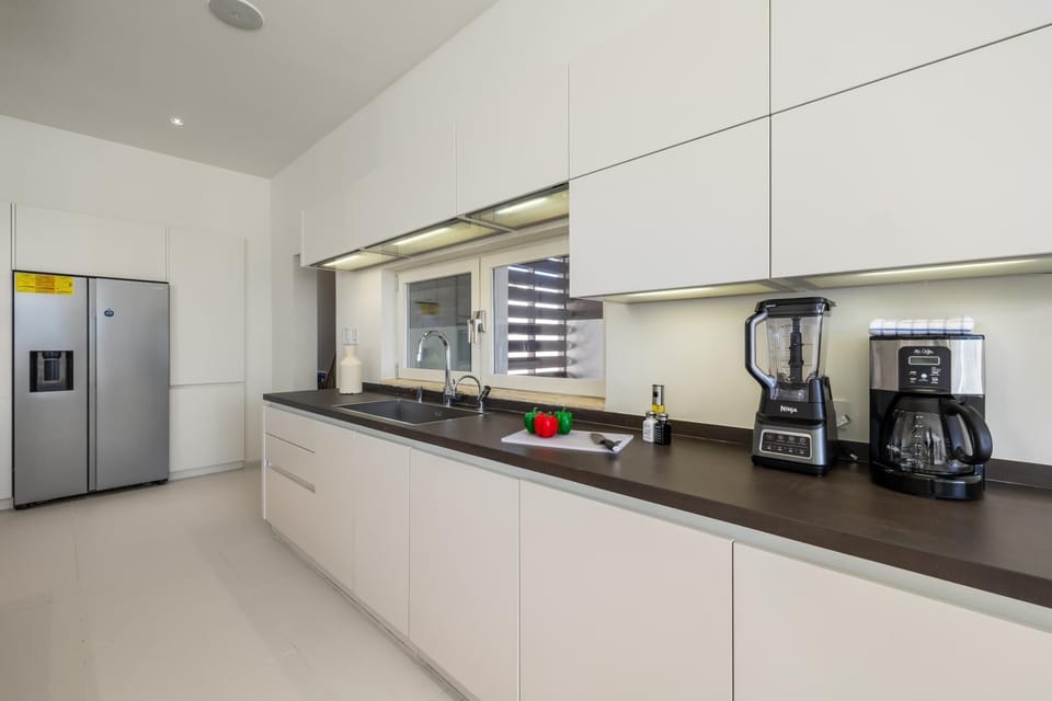 This stylish kitchen combines modern appliances with expansive countertops, offering both functionality and elegance.