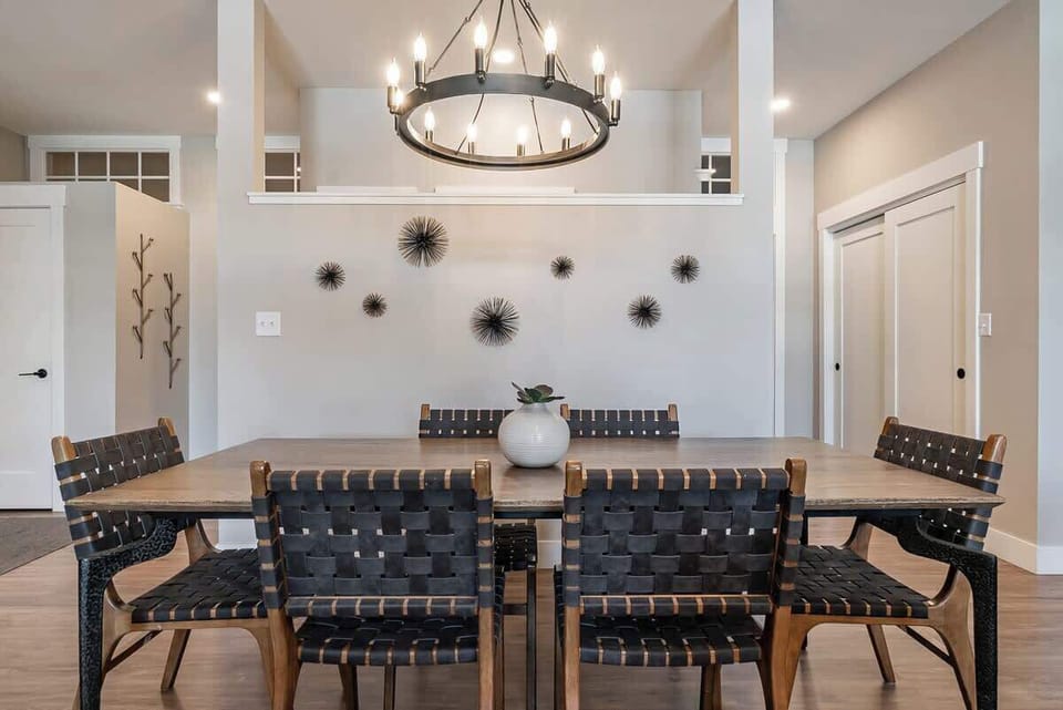 Dine in style at this elegant table for 8, featuring a modern chandelier, designer seating, and warm contemporary decor—perfect for gathering with loved ones.