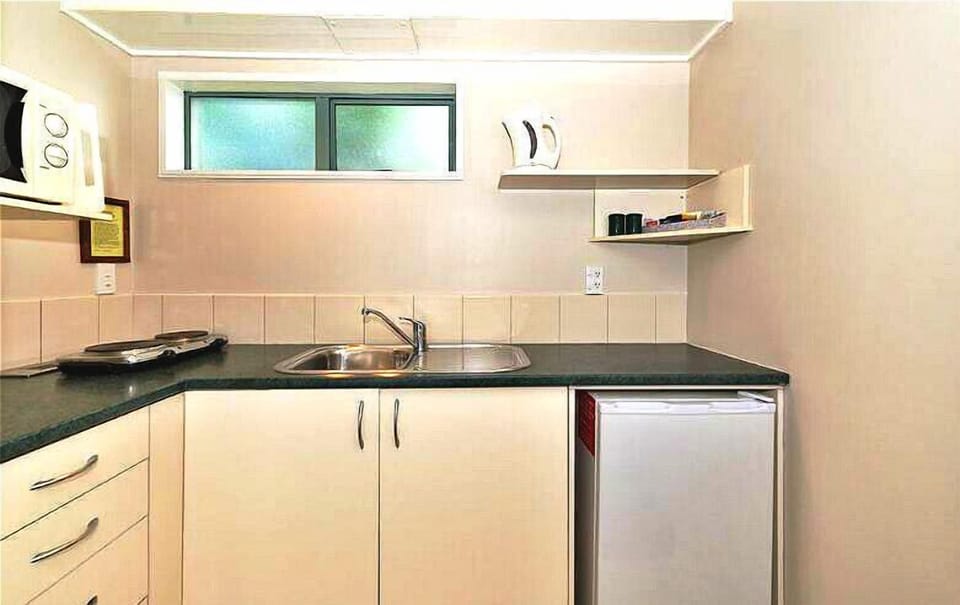Family Triple Room, City View | Private kitchen | Fridge, microwave, dining tables