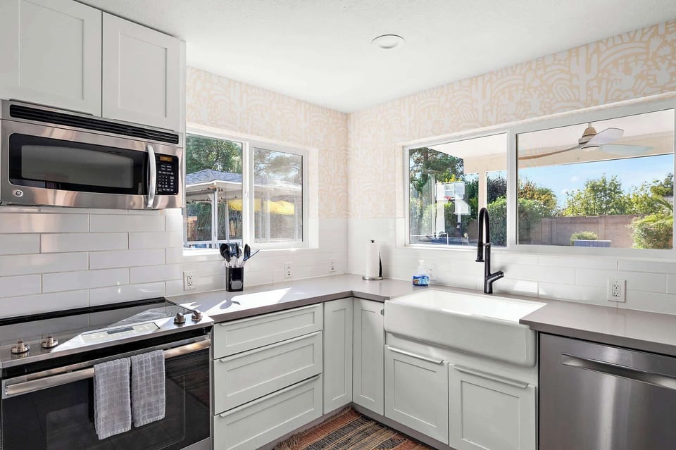 Savor every moment! Our fully stocked kitchen invites you to whip up meals with a view and easy access to the outdoors